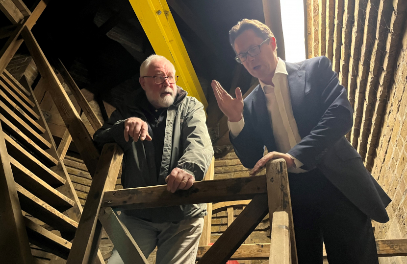 Alex Burghart MP on St Thomas's bell tower with bell ringer Chris Bailey